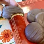 Vegan tagalongs on a plate with a bite taken out of one